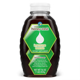 Amazing Herbs HoneyZest frasco derramando miel cruda para bienestar diario