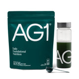 AG1 bottle with shaker on counter for convenient daily nutrition.