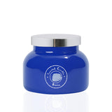 Vela Aroma Bay Ozone en vaso de vidrio azul con tapa plateada para decoración moderna.