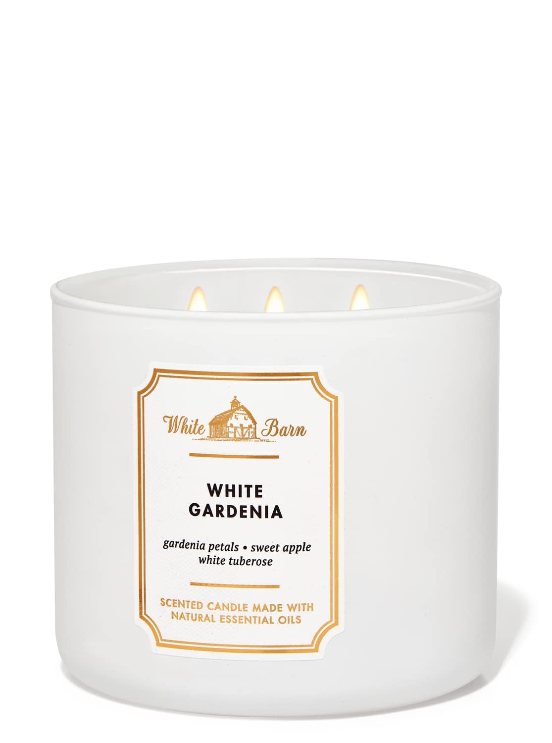 Bath & Body Works White Barn vela 3 mechas, llama encendida y aroma suave.