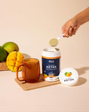 Bella All Natural Detox Mango, taza lista para verter en líquido.