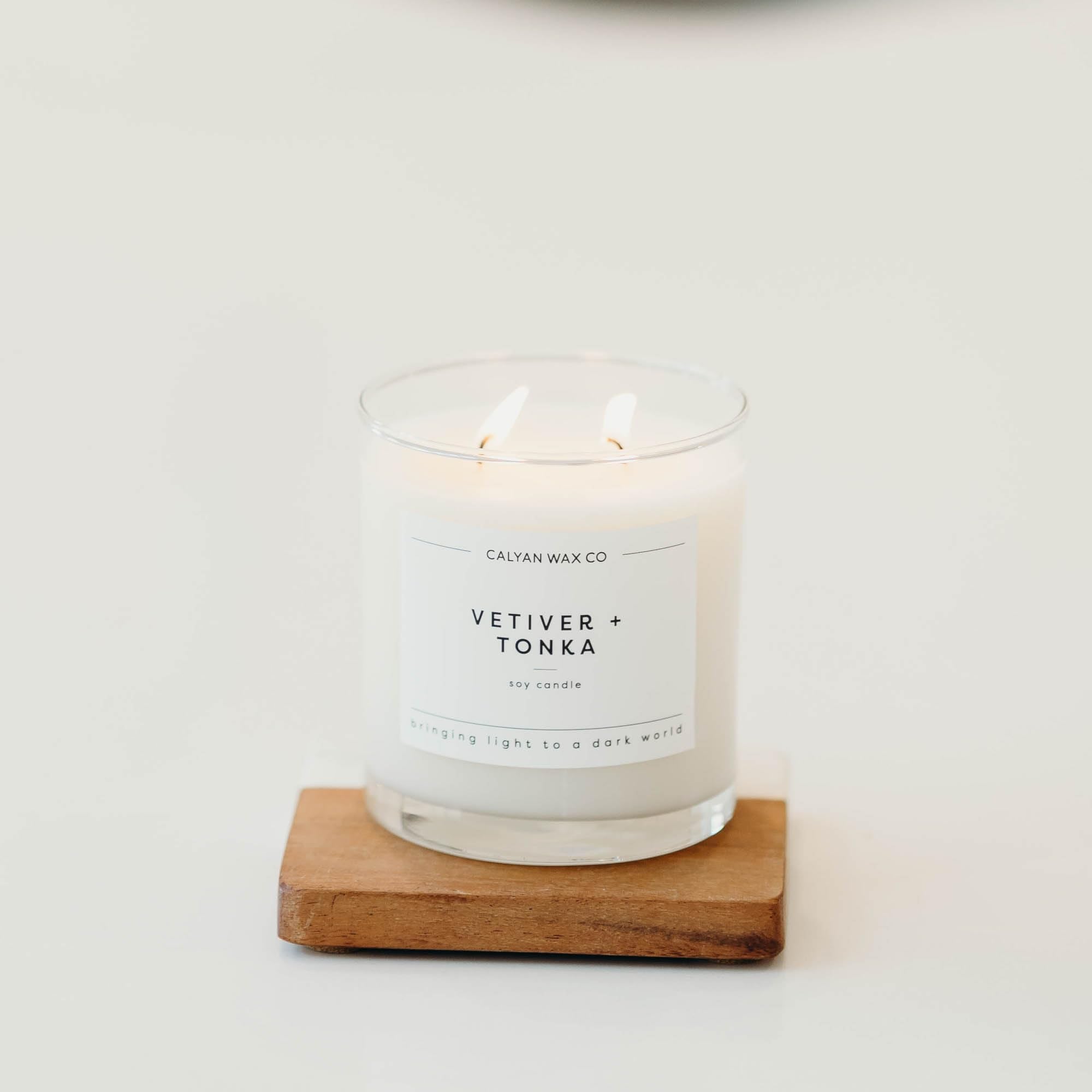 Tono ámbar de la vela Vetiver Tonka creando profundidad aromática.