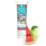 Pasta dental infantil Desert Essence con empaque de manzana verde y sandía, sabor agradable para brushing.