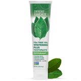 Pasta Desert Essence con aceite de árbol de té en envase, cuidado natural para blanqueado suave.