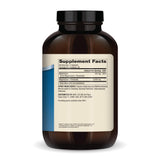 Dr. Mercola Magnesium Advanced, cápsulas en mano, posible apoyo a un descanso más reparador.