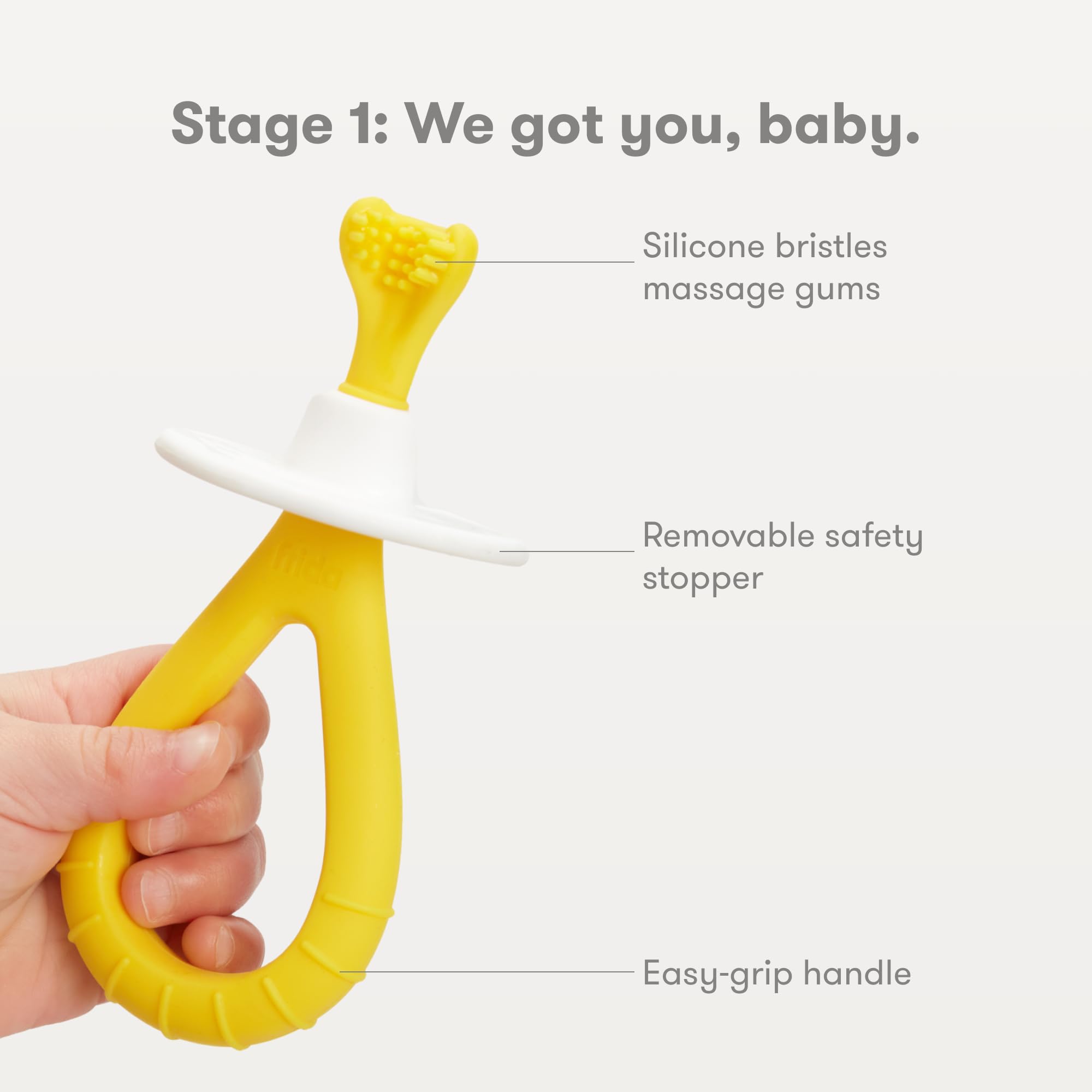 Mango ergonómico de silicona Frida Baby, agarre cómodo para manos pequeñas.