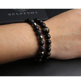 Pulsera GDLKPYHS con ónix negro y hematita para protección y estilo urbano.