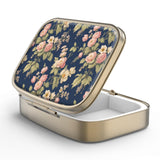 Caja de pastillas Hion con espejo retro bronce, ideal para retoques rápidos.