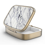 Caja de píldoras Hion con espejo retro bronce, ideal para retoques y organización diaria.