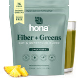 Hona Fiber + Greens polvo verde en vaso para energía suave