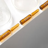 La Cabine Revive Elixir – imagen en un baño iluminado, ritual de belleza.