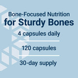 Life Extension Bone Restore mano sosteniendo cápsulas para consumo diario