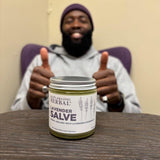 Envase sostenible de Ora's Amazing Herbal Salve, vidrio sin plástico.