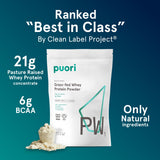Puori PW1 tub opened beside shaker for vanilla protein shake