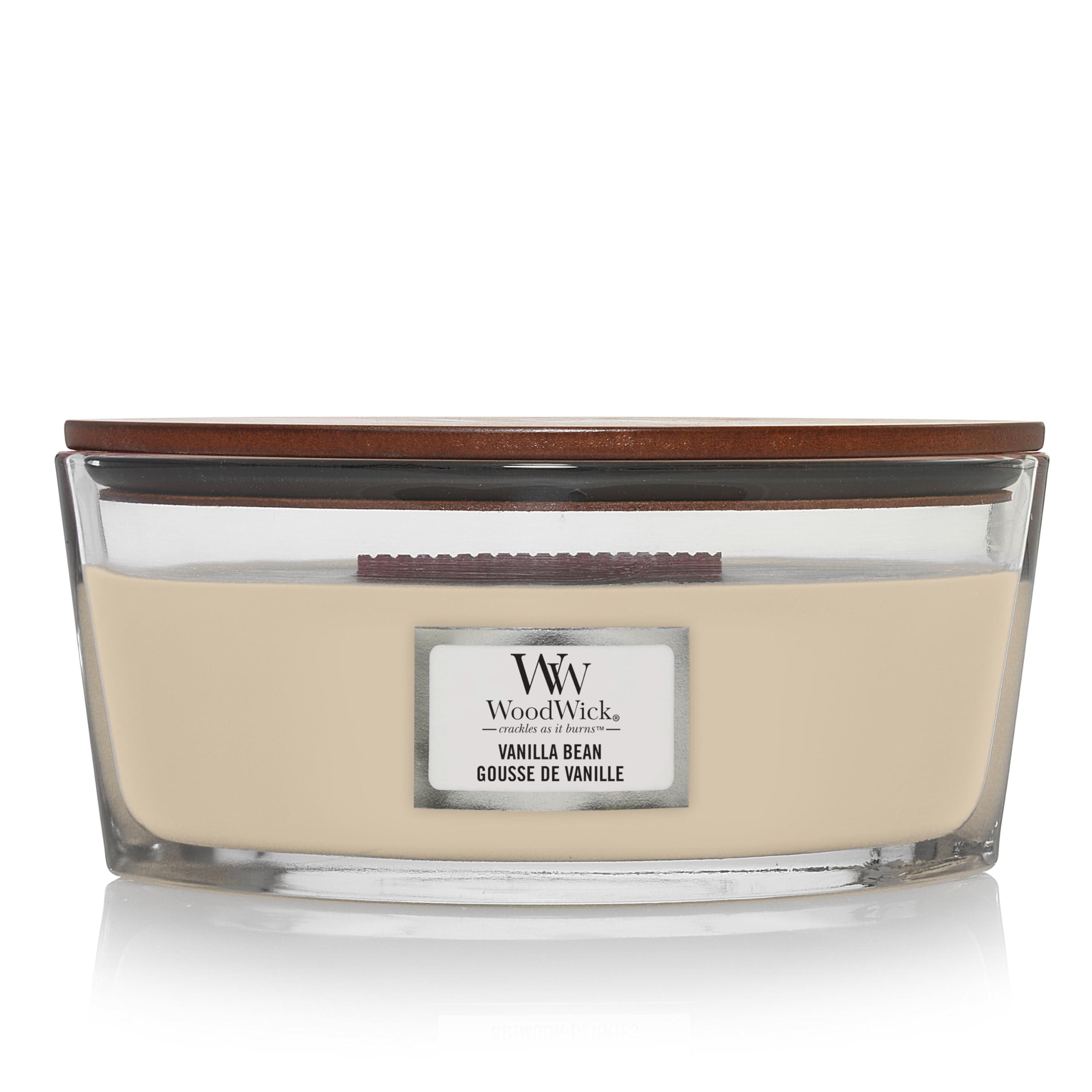 Vela WoodWick Elipsa Vainilla encendida con crepitar suave para relajación aromática.