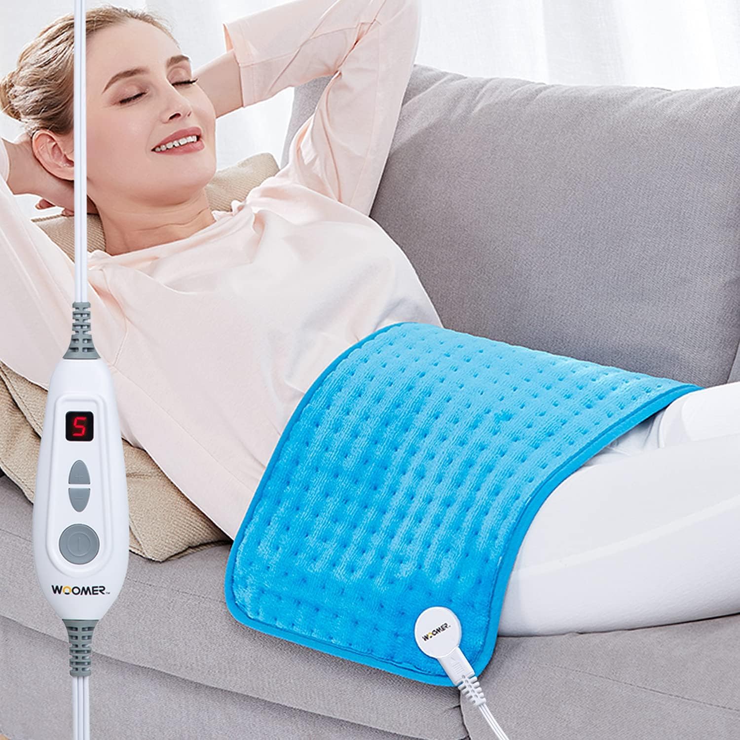 WOOMER almohadilla térmica extralarga en cama para relajación diaria.